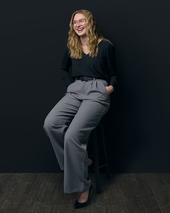 a young professional sitting on a stool