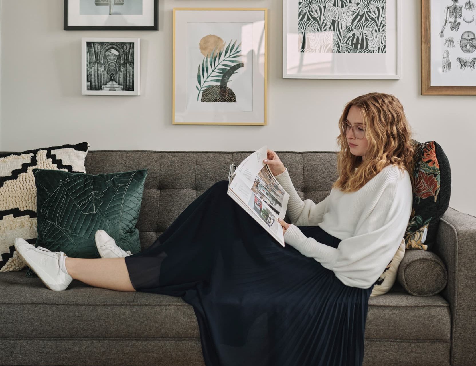 Young female professional reading on the couch