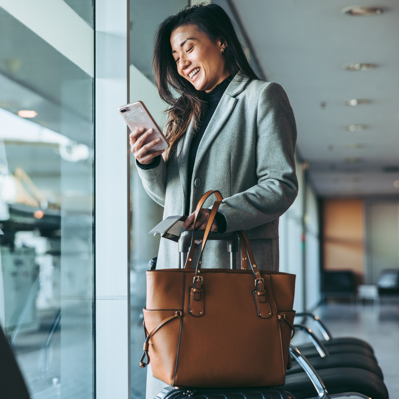 Woman smiling at her mobile device