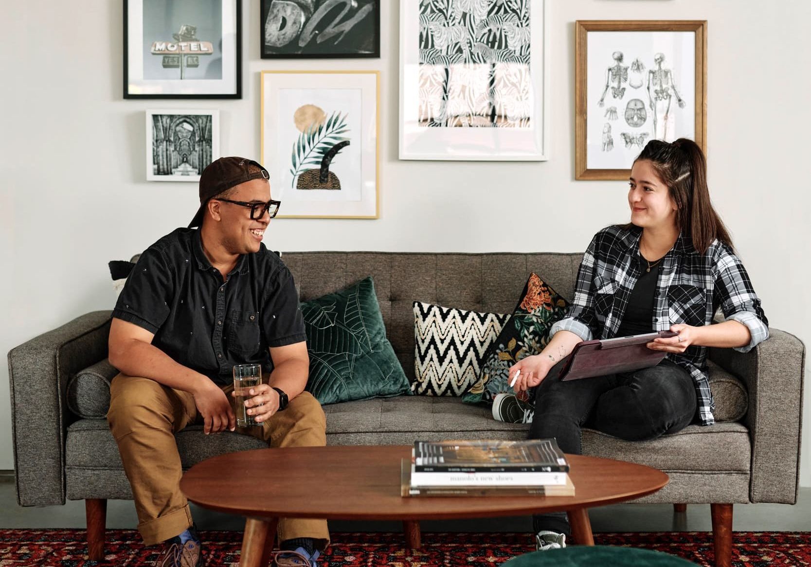 Two Cinnamon Toast employees sitting on a couch