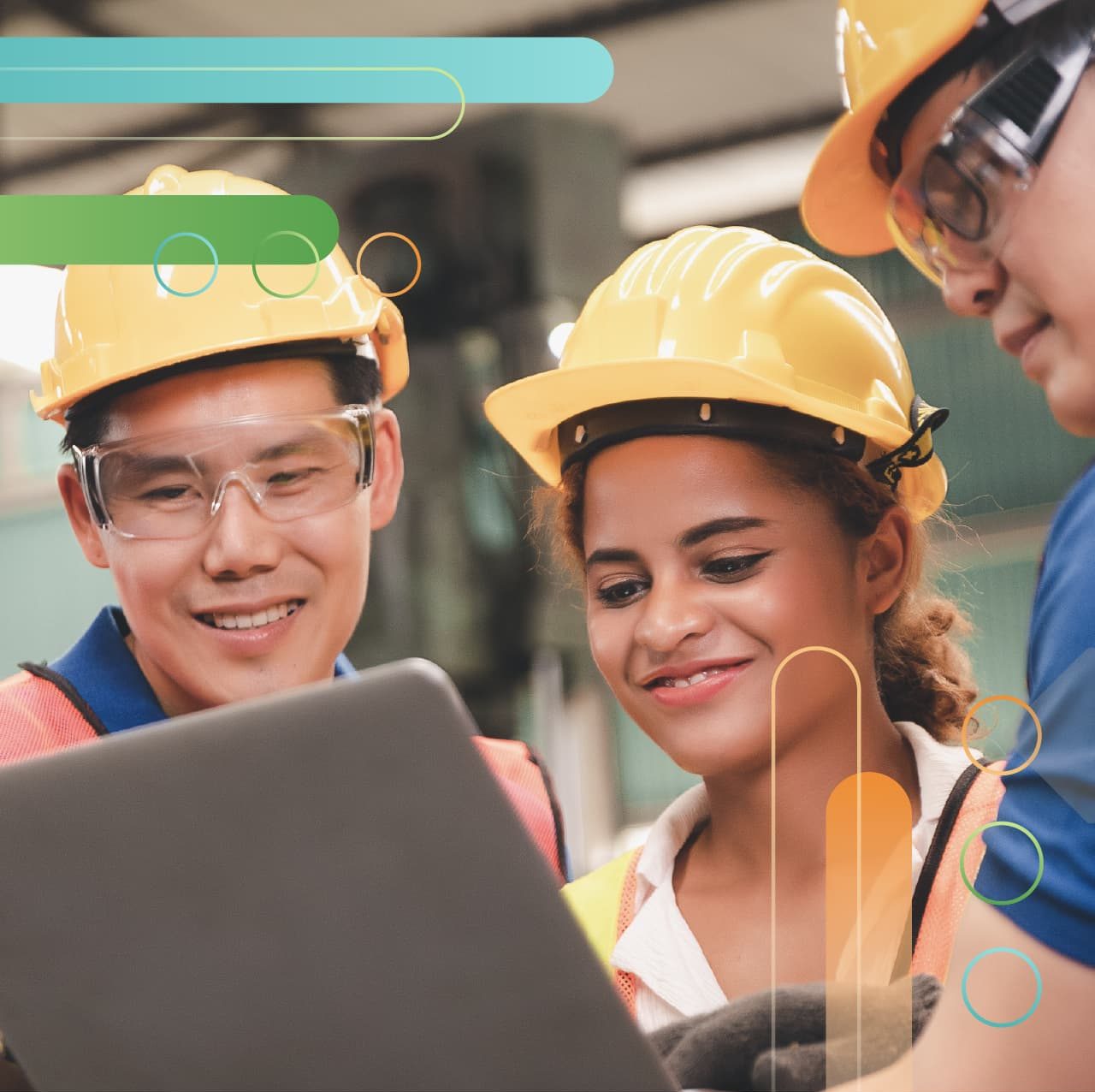 3 People wearing hardhats looking at a laptop